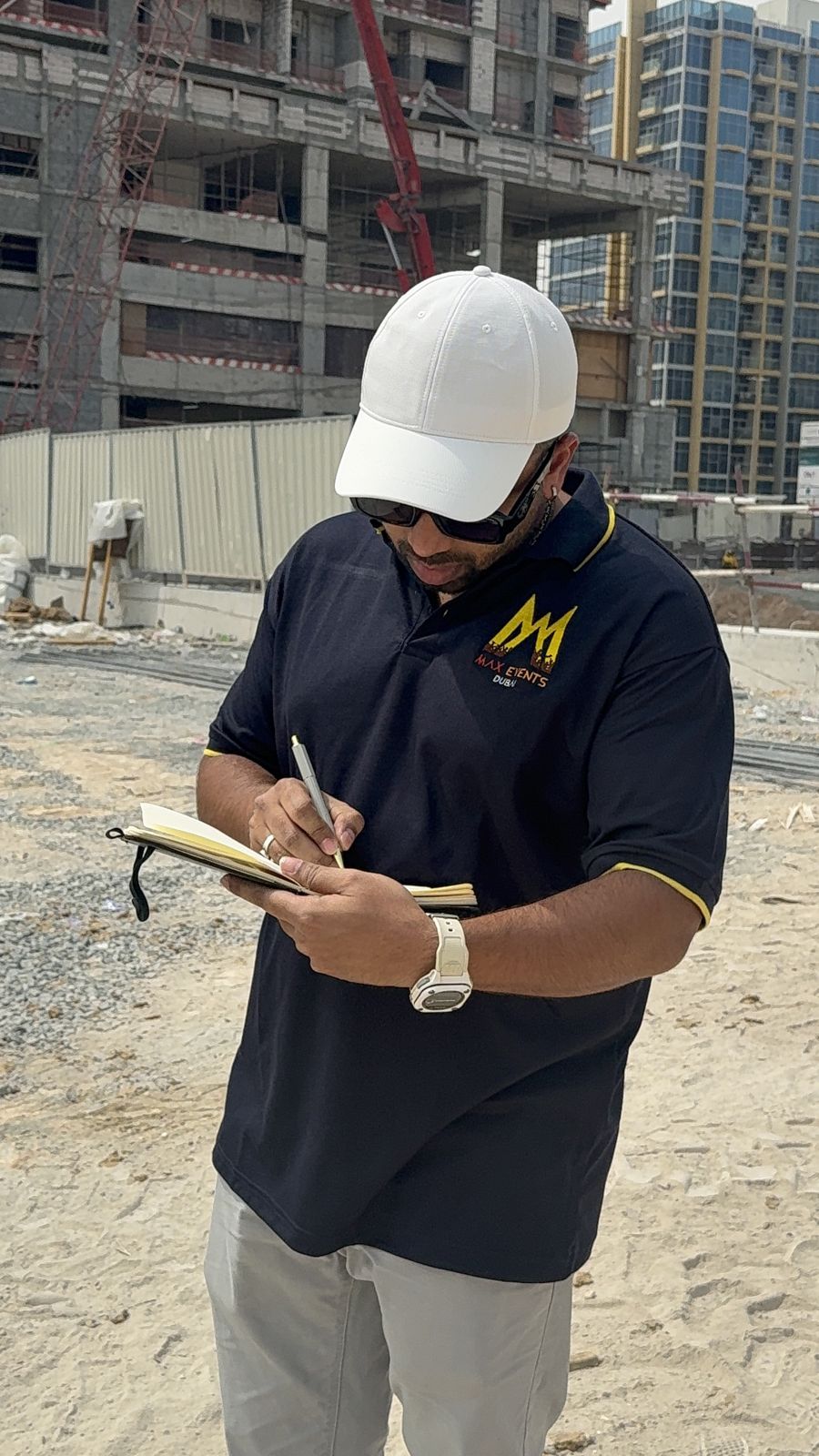 Max Events Dubai creative director taking site recce notes on the empty Weston by Wadan plot before the groundbreaking ceremony